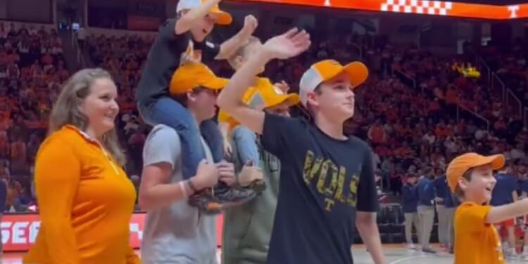 On Dec. 9, the family of Lieutenant Commander Zachary Smith attended a Tennessee Volunteers basketball game in Knoxville, Tennessee, and took the court during a commercial break to hear a special message from the deployed husband and father, but then they got a special surprise.