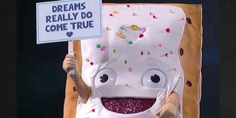 The giant Pop Tart character waved a sign saying "Dreams Really Do Come True" as it was lowered into the super-sized toaster.