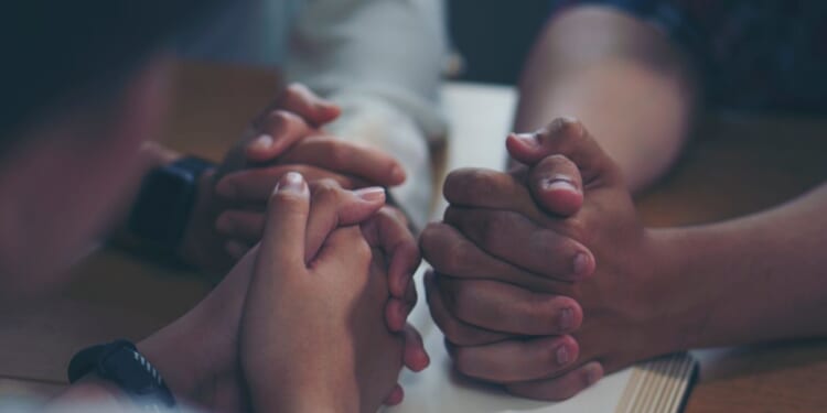 The above stock image is of people praying.