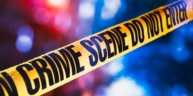 Stock image of police tape at a crime scene.