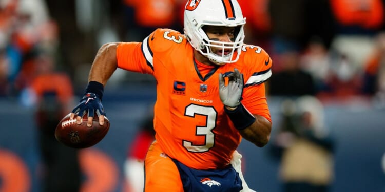 Russell Wilson of the Denver Broncos scrambles out of the pocket during the third quarter of a game against the New England Patriots at Empower Field at Mile High on Sunday in Denver.