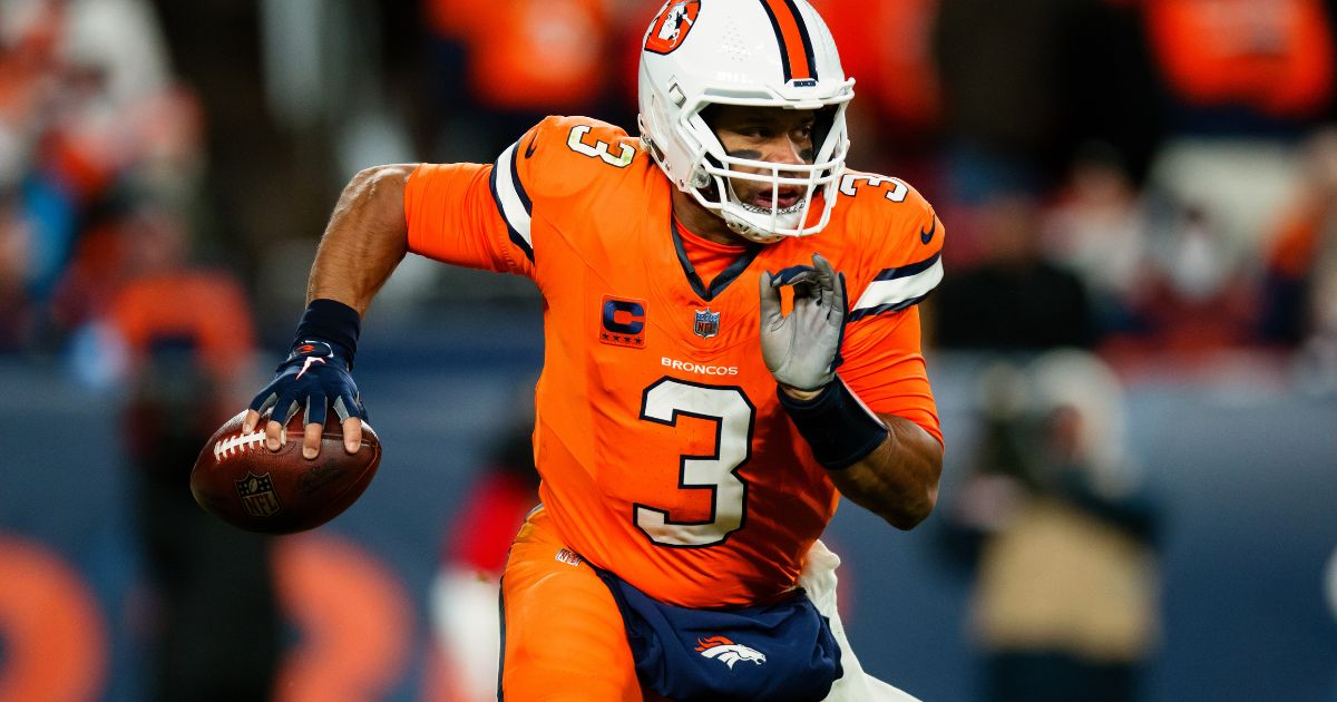 Russell Wilson of the Denver Broncos scrambles out of the pocket during the third quarter of a game against the New England Patriots at Empower Field at Mile High on Sunday in Denver.