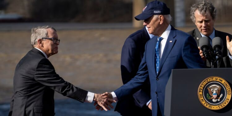 President Joe Biden shakes hands with Ohio Gov. Mike DeWine on January 4, 2023 in Covington, Kentucky.