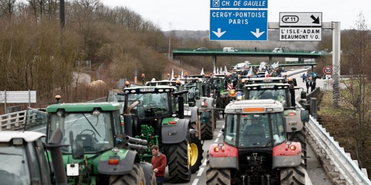 French farmers stop their tractors on the A16 motorway on Tuesday as they maintain roadblocks on key highways into Paris for a second day, increasing pressure on the government for more concessions on pay, tax and regulations. Farmers protests across Europe are growing as they demand better conditions to grow produce.