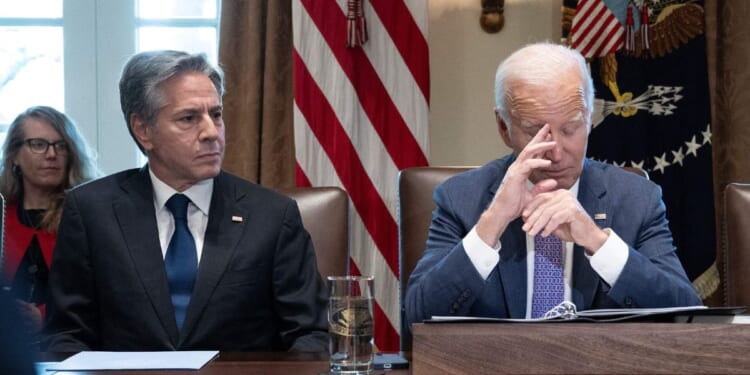 Secretary of State Antony Blinken, left, and President Joe Biden, right, look on during a Cabinet meeting in the Cabinet Room of the White House in Washington, D.C., on Oct. 2.