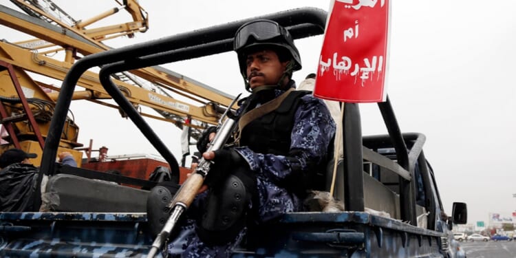 A Yemeni security soldier loyal to the Houthi movement guards a truck during a protest held to condemn the U.S. for redesignating Houthis as a global terrorist group, and against the U.S.-British aerial attacks conducted on Yemen on Friday in Sana'a, Yemen.