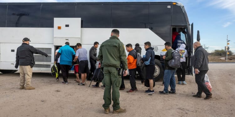 A group of illegal immigrants wait to board a U.S. Customs and Border Protection bus after illegally crossing the U.S.-Mexico border in Eagle Pass, Texas, on Jan. 7.