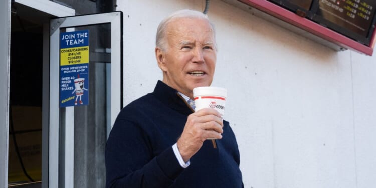 President Joe Biden holds a milkshake during a stop at a Cook Out restaurant in Raleigh, North Carolina, on Thursday.