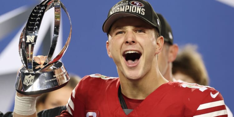 San Francisco 49ers quarterback Brock Purdy holds up the George Halas Trophy after defeating the Detroit Lions in the NFC Championship Game in Santa Clara, California, on Sunday.