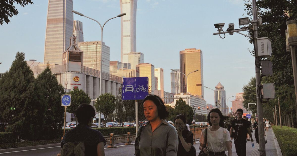 People walk near the Central Business District during the rush hour in Beijing on Aug. 14.