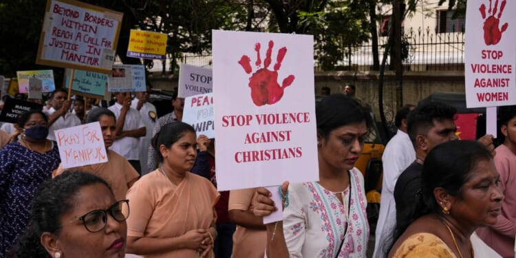 Catholic Christians hold placards and participate in a peace rally against violence in the northeastern Manipur state, in Hyderabad, India, Aug. 25.