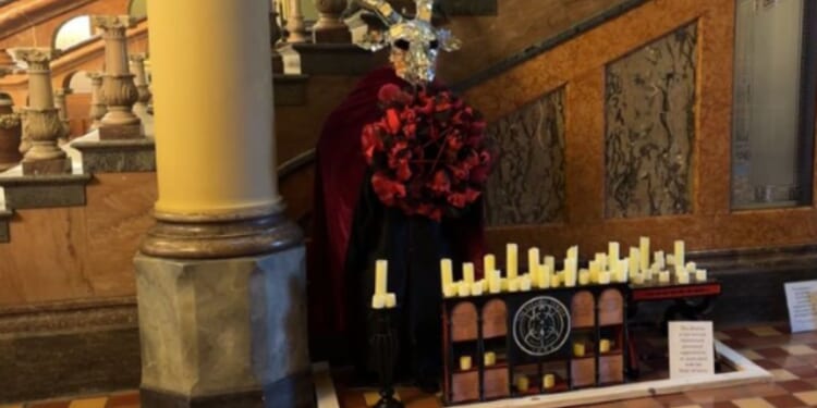 Michael Cassidy is being charged with a hate crime for destroying the pictured Satanic Temple display that was located in the Iowa Capitol.