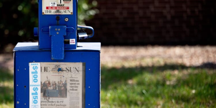 A Baltimore Sun newspaper bin stands in the Maryland city in 2021. Conservative media mogul David Smith is the new owner of the outlet.