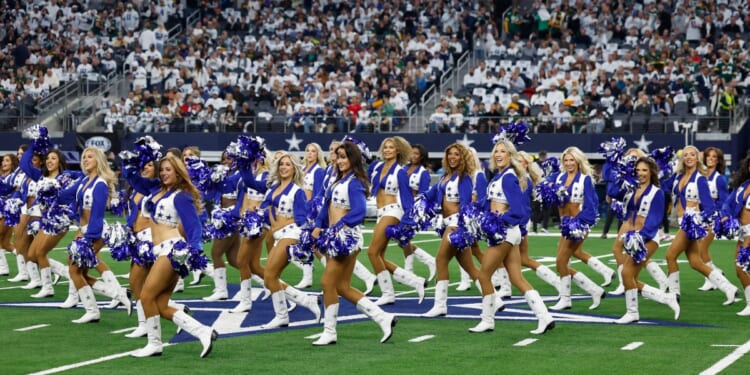 The Dallas Cowboys cheerleaders perform before the team's wild-card playoff game against the Green Bay Packers in Arlington, Texas, on Sunday.