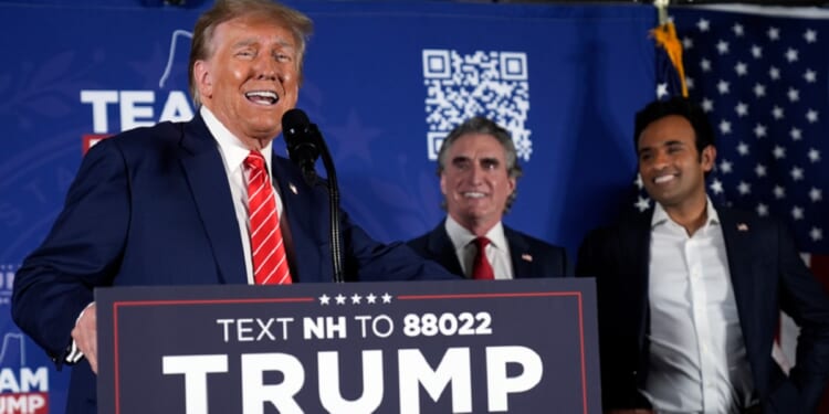 Former President Donald Trump speaks as former Republican presidential contenders North Dakota Gov. Doug Burgum, center, and Vivek Ramaswamy, right, appear on stage Monday during a campaign event in Laconia, New Hampshire.