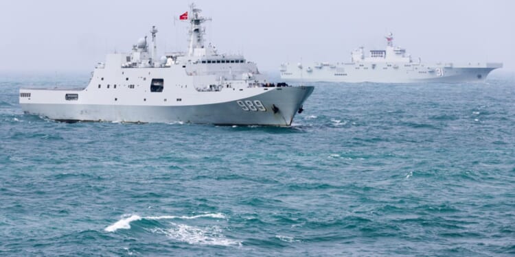 The amphibious dock landing ship Changbaishan and the amphibious assault ship Hainan attached to a landing ship flotilla of the Chinese navy steam in formation during a maritime training exercise in late December.