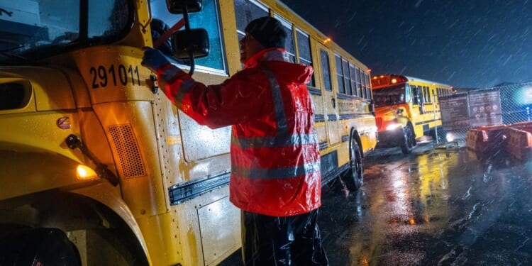 Nearly 2,000 migrants are evacuated by school buses from tents at Floyd Bennett Field to a local high school in preparation for a storm with estimated wind speeds to be more than 70 mph on January 9 in the Brooklyn borough of New York City. More than 100,000 migrants have arrived in New York City over the last year.