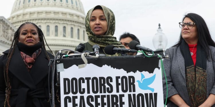 Three members of the "squad" - Democratic Reps. Cori Bush, left, Ilhan Omar, center, and Rashida Tlaib, right - speak at a news conferences outside the U.S. Capitol in Washington, D.C., on Dec. 7.