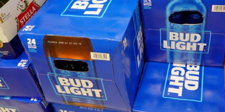 Cases of Bud Light, made by Anheuser-Busch, sit on a store shelf in Miami.