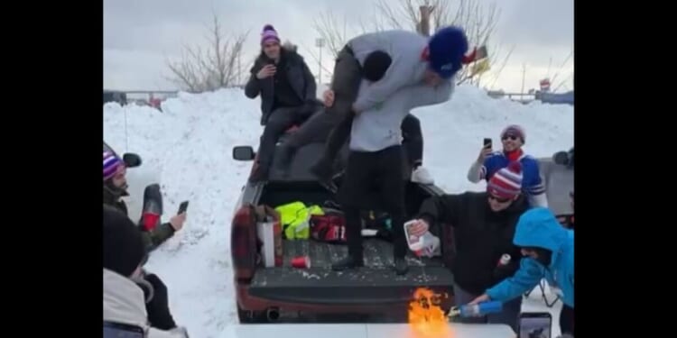 A Detroit Lions fan catches fire while tailgating with Bills fans in Buffalo on Sunday.