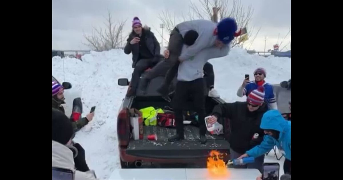 A Detroit Lions fan catches fire while tailgating with Bills fans in Buffalo on Sunday.