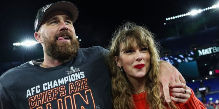 Travis Kelce, left, and Taylor Swift, right, celebrate after the Kansas City Chiefs defeat the Baltimore Ravens in Baltimore on Sunday to become the AFC Champions.