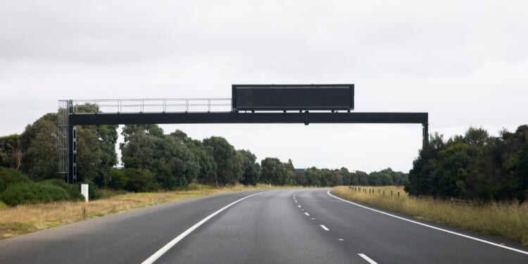 A stock photo shows a electronic highway sign with no message.