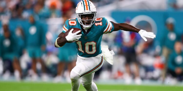 Tyreek Hill of the Miami Dolphins carries the ball against the Dallas Cowboys during the fourth quarter of a game at Hard Rock Stadium on Dec. 24, 2023, in Miami Gardens, Florida.