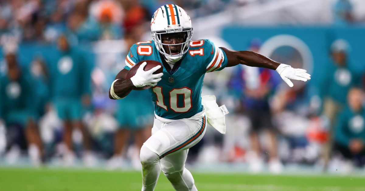 Tyreek Hill of the Miami Dolphins carries the ball against the Dallas Cowboys during the fourth quarter of a game at Hard Rock Stadium on Dec. 24, 2023, in Miami Gardens, Florida.