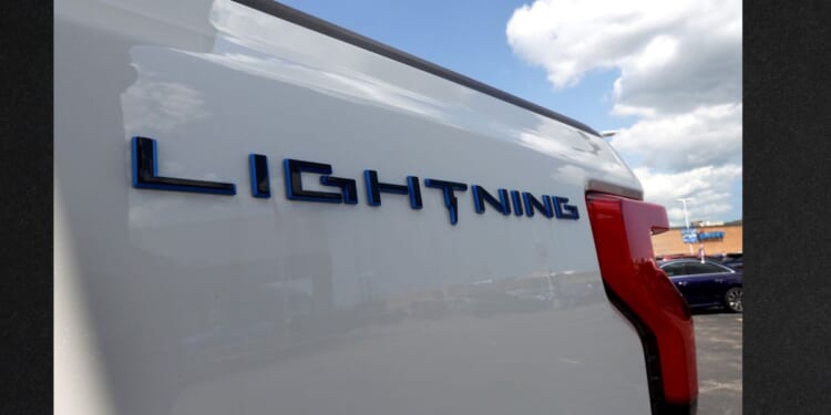 A 2023 Ford F-150 Lightning EV is offered for sale at Golf Mill Ford on July 18, 2023, in Niles, Illinois. Ford announced that it is slashing production of the Lightning truck and shifting hundreds of workers to assembly lines for gas-powered models.