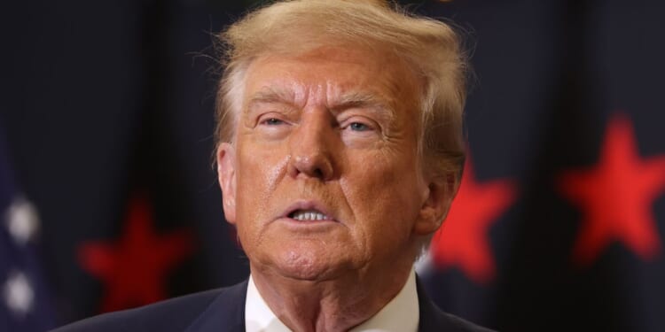 Republican presidential candidate and former President Donald Trump looks on during a campaign event in Waterloo, Iowa, on Dec. 19.