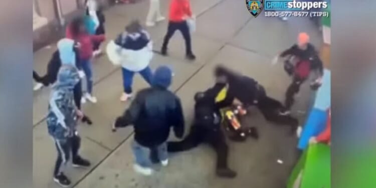 A gang of migrants attacks two New York City police officers on Saturday.