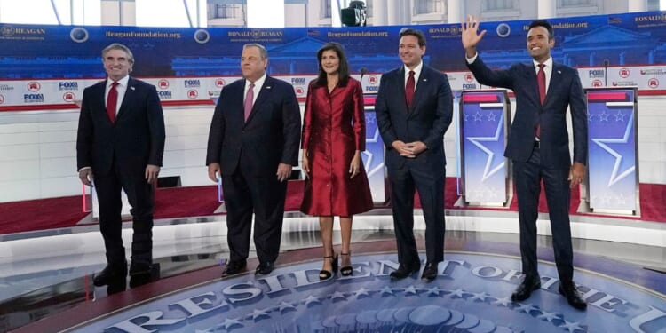 North Dakota Gov. Doug Burgum, left, stands with other Republican presidential candidates during a GOP primary debate at the Ronald Reagan Presidential Library in Simi Valley, California, on Sept. 27.