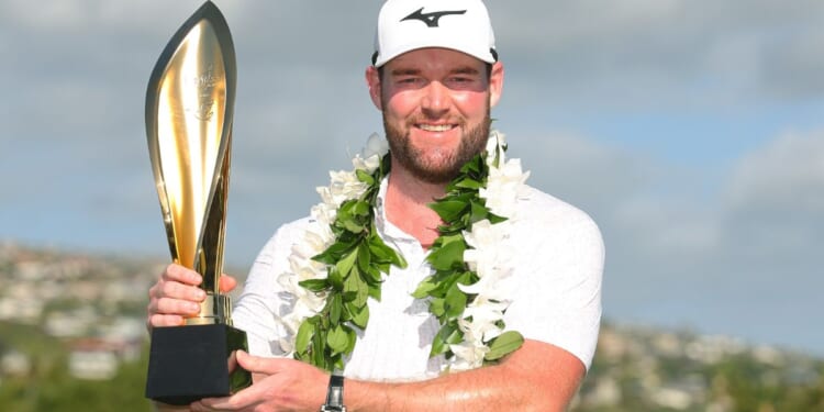 Grayson Murray of the United States poses with the trophy after winning the Sony Open in Honolulu, Hawaii, on Sunday.