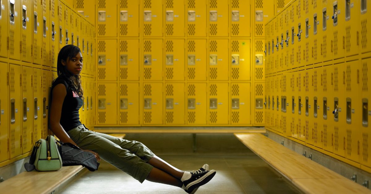 This stock image pictures a teenage girl in a female locker room of a high school. A West Virginia mother recently argued against a school board for allowing males who claim to be transgender access to the female locker rooms.