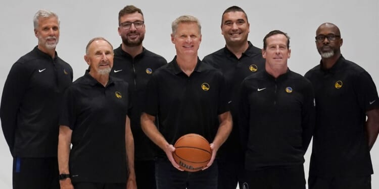 Golden State Warriors head coach Steve Kerr, center, poses for photos with assistants Bruce Fraser, clockwise from top left, Chris DeMarco, Dejan Milojevic, Kris Weems, Kenny Atkinson and Ron Adams during the NBA basketball team's media day in San Francisco, California, on Oct. 2.