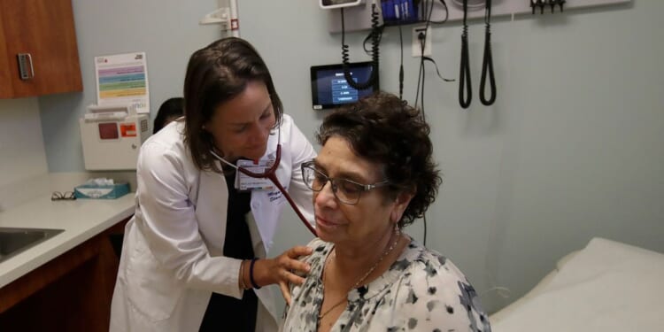 a doctor examining a patient in her office