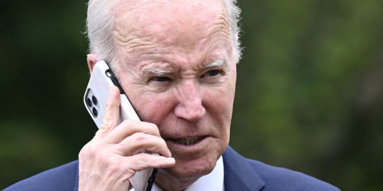 President Joe Biden speaks on the phone during a National Small Business Week event in the Rose Garden of the White House in Washington, D.C., on May 1.