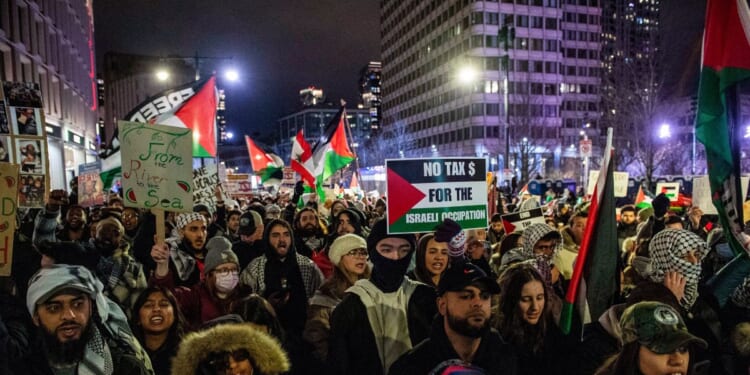 Pro-Palestinian demonstrators march in Boston, Massachusetts on December 31, 2023.