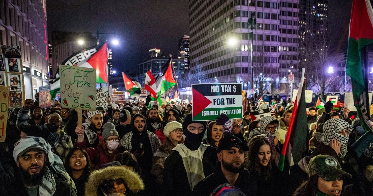 Pro-Palestinian demonstrators march in Boston, Massachusetts on December 31, 2023.