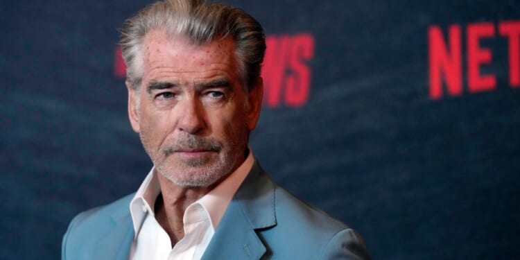 Actor Pierce Brosnan poses at a special screening of the film "The Out-Laws," June 26, at the Regal LA Live theaters in Los Angeles.