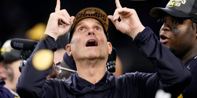 Michigan head coach Jim Harbaugh celebrates after winning the national championship NCAA college football playoff game, Jan. 8, in Houston.