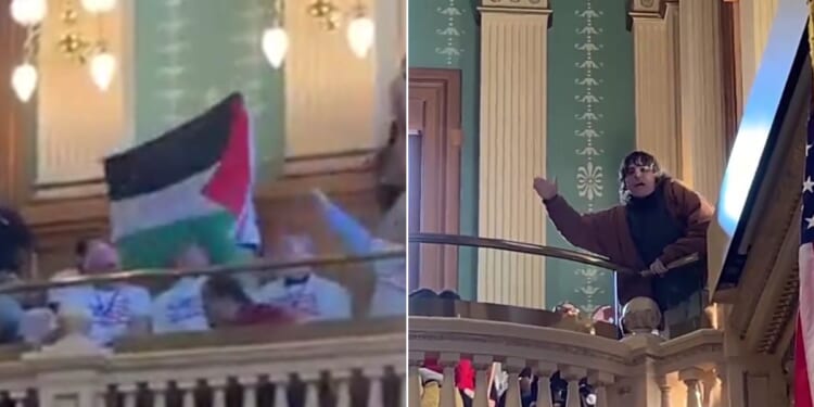 One protester waves a Palestinian flag, left, as another screamed slogans from the gallery.