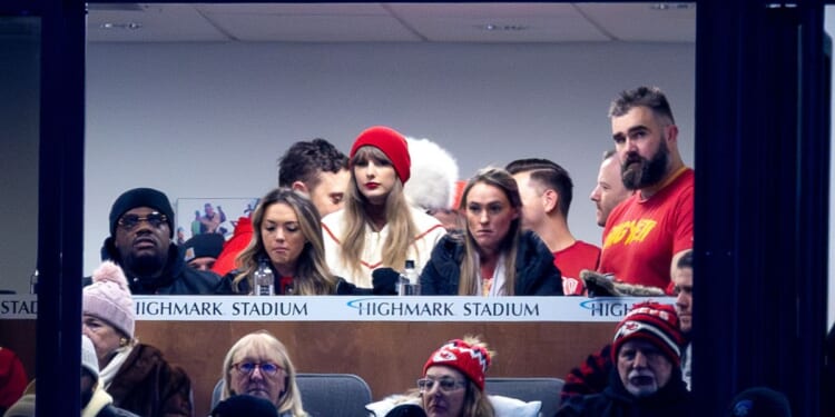 Jason Kelce, far right, and Taylor Swift, center, watch the Kansas City Chiefs play the Buffalo Bills in Orchard Park, New York, on Sunday.