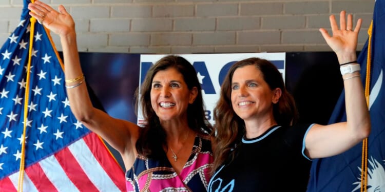 Former South Carolina Gov. Nikki Haley, left, cheers alongside Rep. Nancy Mace, right, during a campaign rally in Summerville, South Carolina, on June 12, 2022.