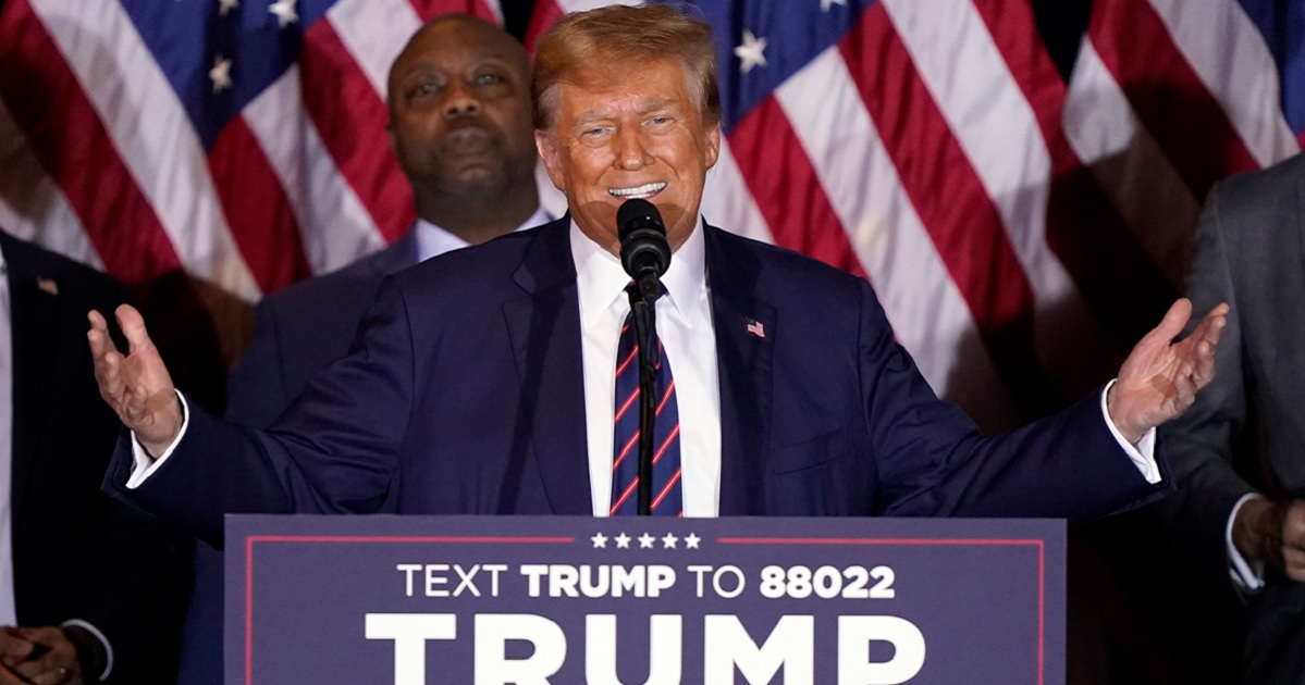 Former President Donald Trump grins as he delivers his victory speech Tuesday night in Nashua, New Hampshire, after winning the Granite State primary.