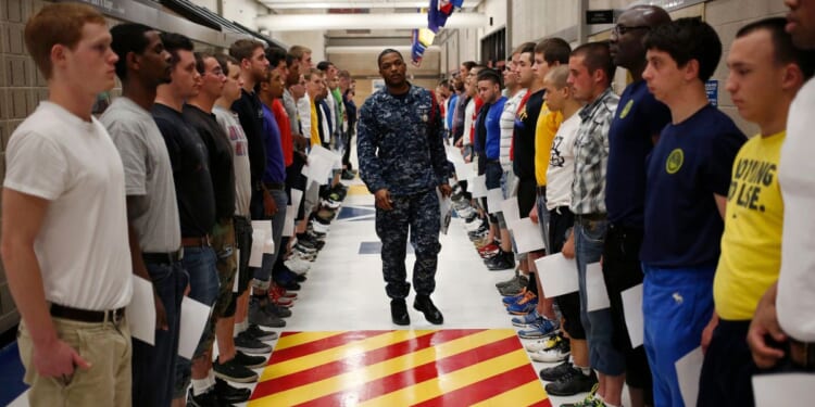 Navy Recruit Division Commander Petty Officer Lewis Dunn, center, inspects a busload of newly arrived Navy Basic Training recruits in Great Lakes, Illinois, on April 8, 2013.