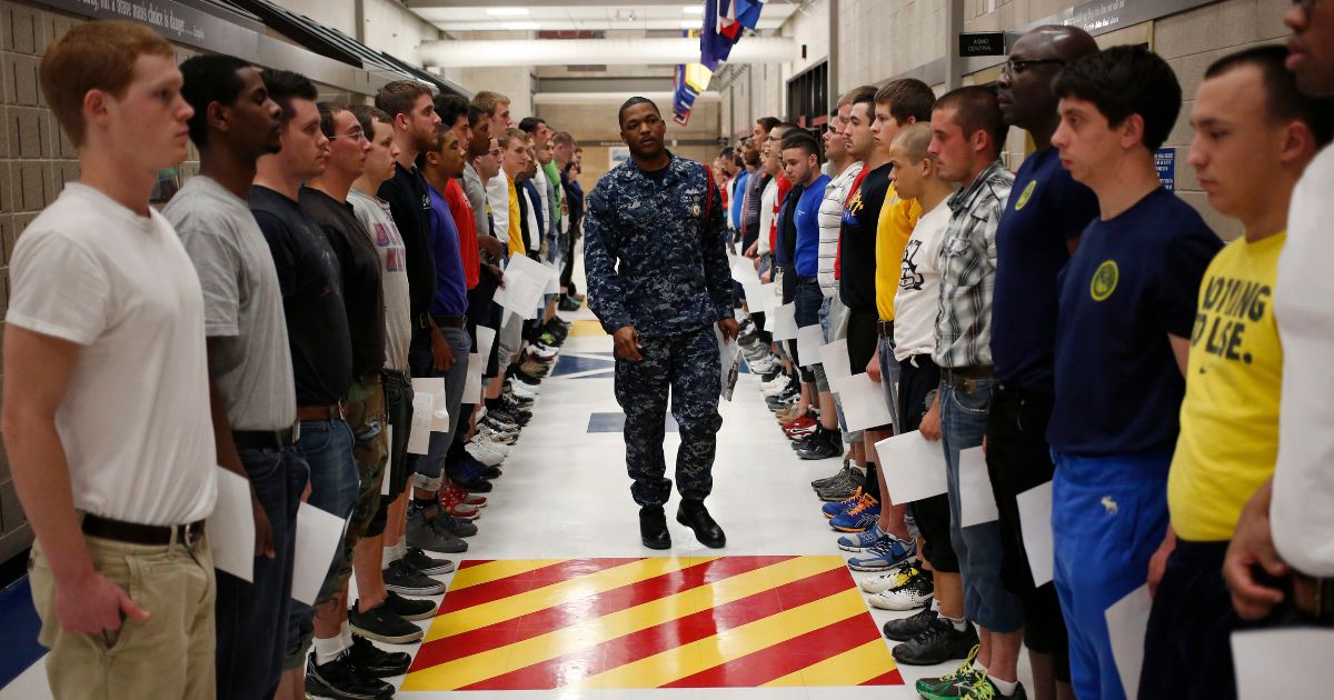 Navy Recruit Division Commander Petty Officer Lewis Dunn, center, inspects a busload of newly arrived Navy Basic Training recruits in Great Lakes, Illinois, on April 8, 2013.