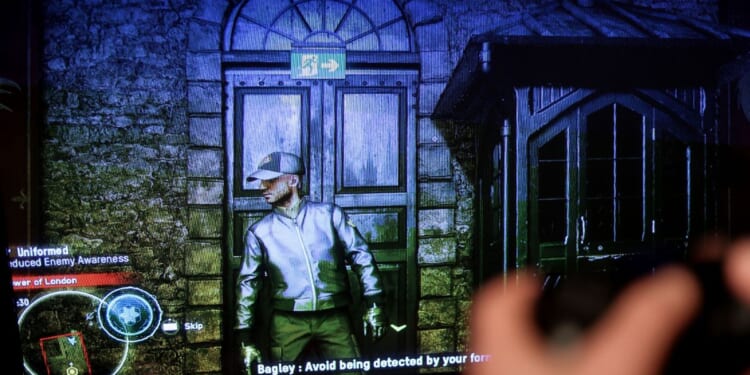 This picture taken on October 28, 2020, in Brussels, shows a screen displaying the new Ubisoft video game "Watch Dogs Legion". The game released on Octoer 28, 2020, by French studio Ubisoft is set in a dystopian near-future London, haunted by authoritarian surveillance and the ghost of Brexit.