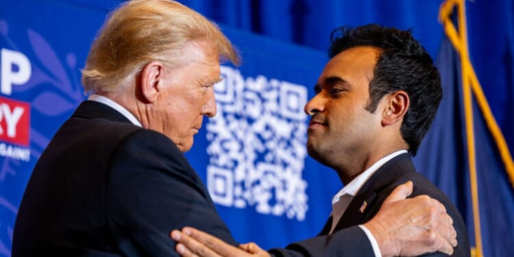 Former President Donald Trump, left, and former Republican presidential hopeful Vivek Ramaswamy, right, embrace during a Trump campaign rally in Atkinson, New Hampshire, on Tuesday. Ramaswamy dropped out of the Republican primary on Monday night and endorsed Trump's campaign.